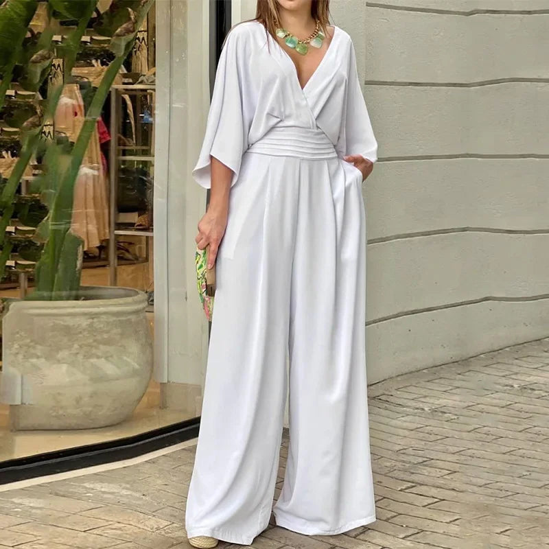 Elegant lös djup V-ringad jumpsuit med fladdermusärmar och vida ben för kvinnor